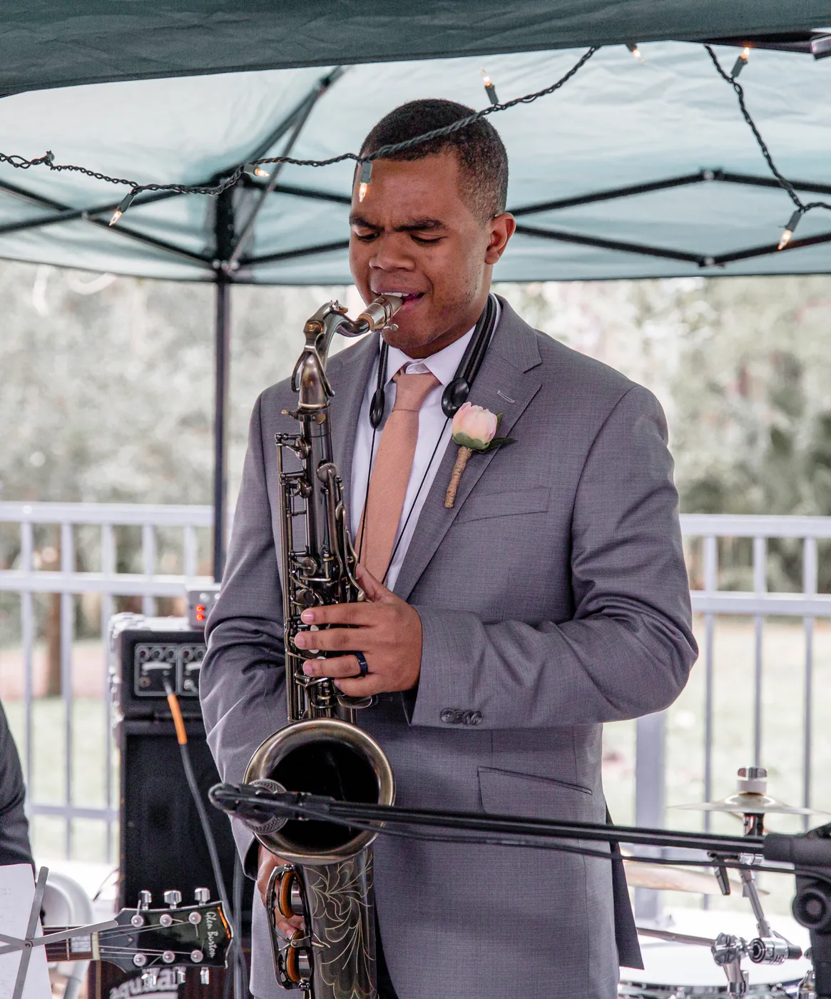 Whale The King playing saxophone at an outdoor set