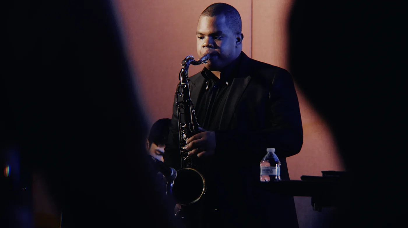 Whale The King on stage with his saxophone